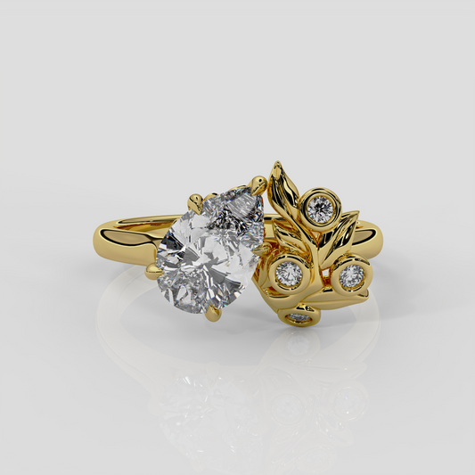 The Berry Engagement Ring by London jewellery designer, Georgina Yvonne. 18ct yellow gold with pear diamond centre and diamond accent stones, leaf and nature inspired design