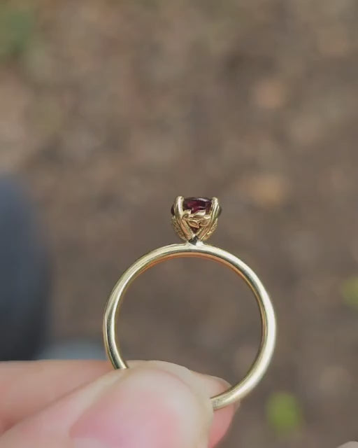 Daisy Garnet Engagement Ring by London jewellery designer, Georgina Yvonne. Nature inspired solitaire 18ct yellow gold engagement ring with floral gallery and oval garnet centre stone