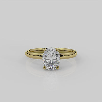 18ct yellow gold Daisy solitaire engagement ring by London jewellery designer, Georgina Yvonne. Nature inspired design with floral gallery and oval diamond centre stone