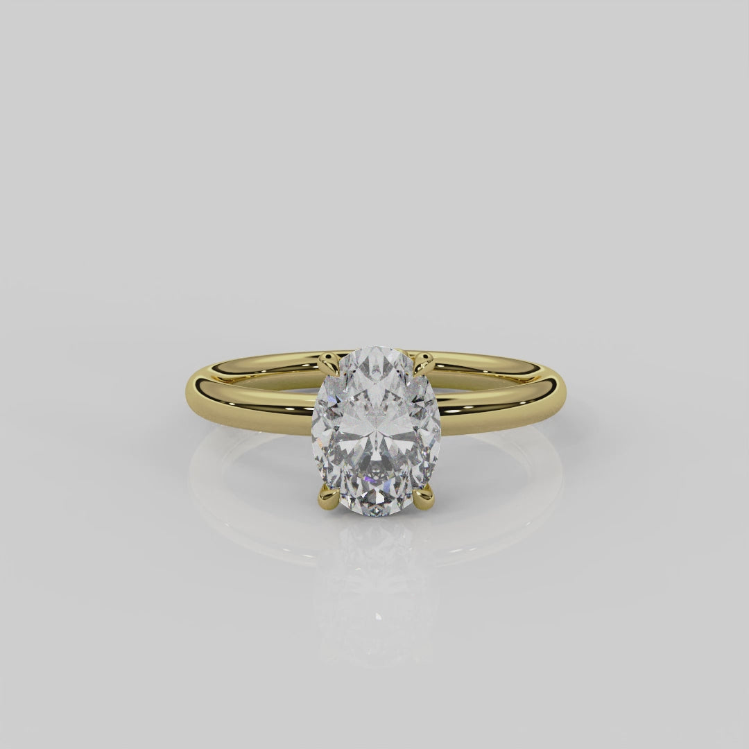 18ct yellow gold Daisy solitaire engagement ring by London jewellery designer, Georgina Yvonne. Nature inspired design with floral gallery and oval diamond centre stone